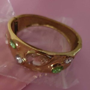 Gold bracelet with pink, white, and green jewels